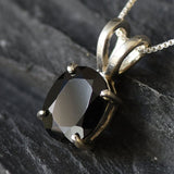 Onyx pendant believed to promote grounding energy and boost inner stability.