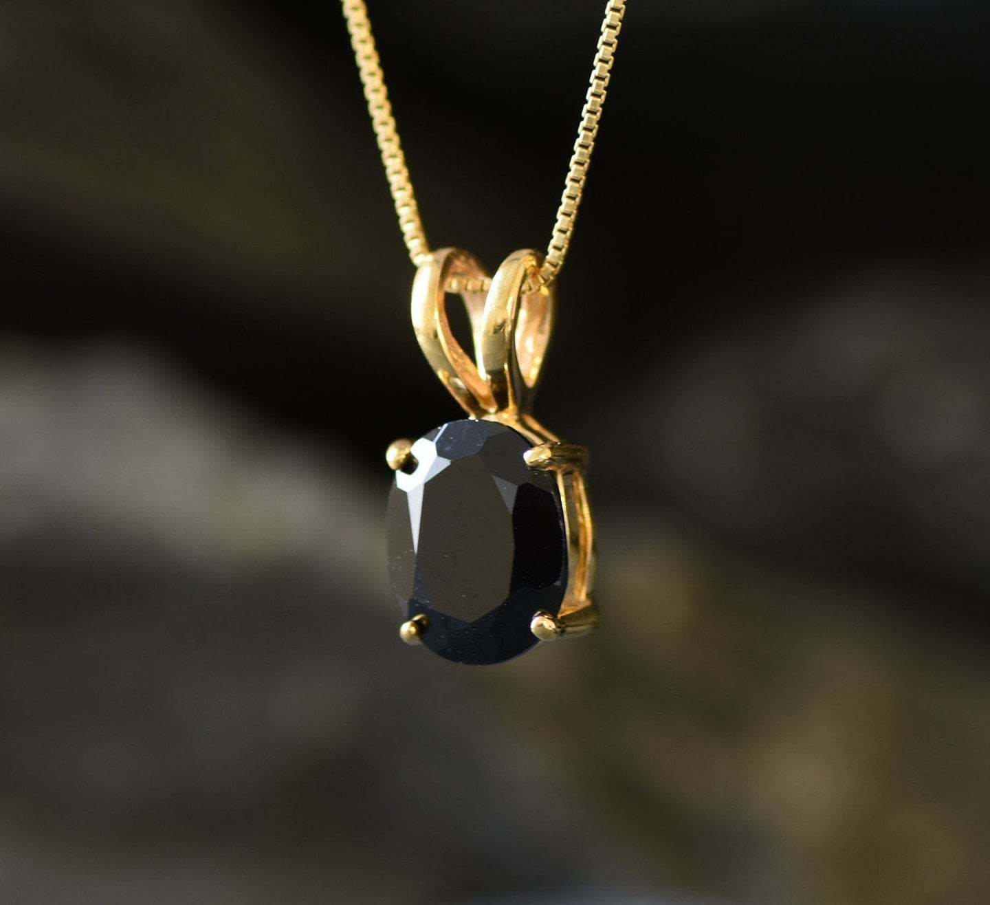 Onyx pendant believed to promote grounding energy and strong inner focus.