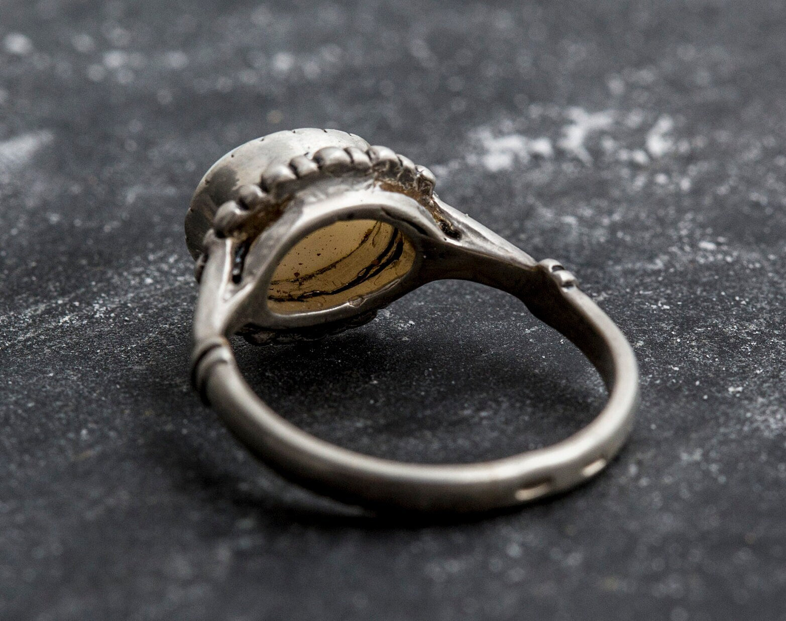 Australian Opal Ring in sterling silver with a horizontal oval cabochon design, white stone showing flashes of fire colors, delicate jewelry style for everyday elegance, meaningful October birthstone gift idea. Perfect for weddings, anniversaries, cocktail parties, and milestone events.