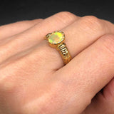 Fire Opal Ring worn on ring finger with natural bare nails, highlighting the ornate gold engraved band and October Birthstone glow, symbolizing love and inspiration, perfect for anniversaries and romantic evenings.