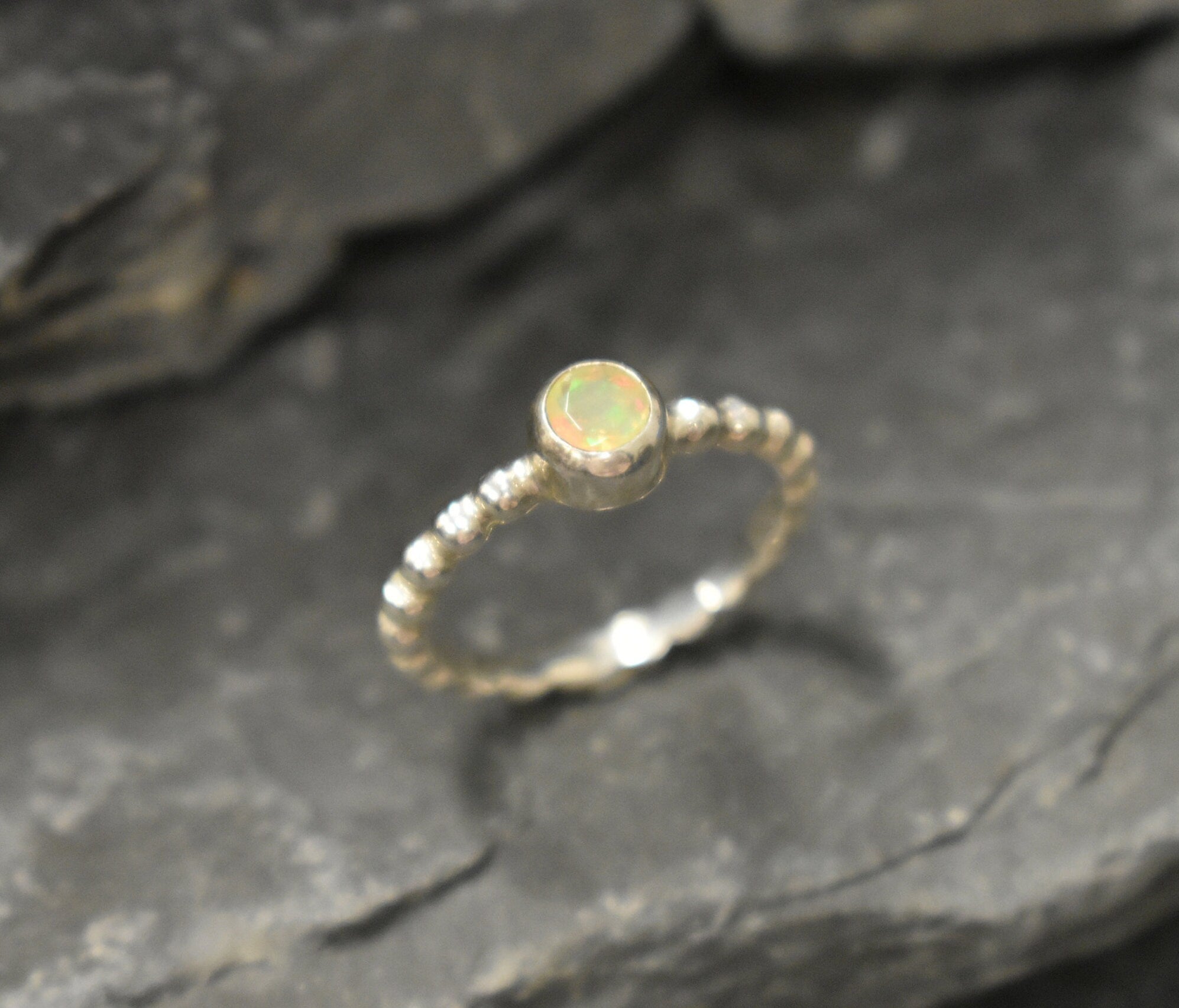 Yellow Fire Opal Bubble Band Ring in sterling silver with bezel set round cut, showcasing flashes of fire colors in a tennis band design for an elegant jewelry style. This durable and timeless piece is a meaningful October birthstone gift idea, symbolizing passion and inspiration. Ideal for birthdays, weddings, anniversaries, and evening occasions where a touch of unique brilliance is desired.