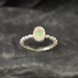 Fire Opal bezel bubble band ring in sterling silver with flashes of fire colors, a dainty jewelry style perfect for everyday elegance and stacking. Offers the benefit of durability with bezel setting and a glowing October birthstone gift idea for loved ones. Ideal to wear for birthdays, anniversaries, engagements, or casual celebrations.