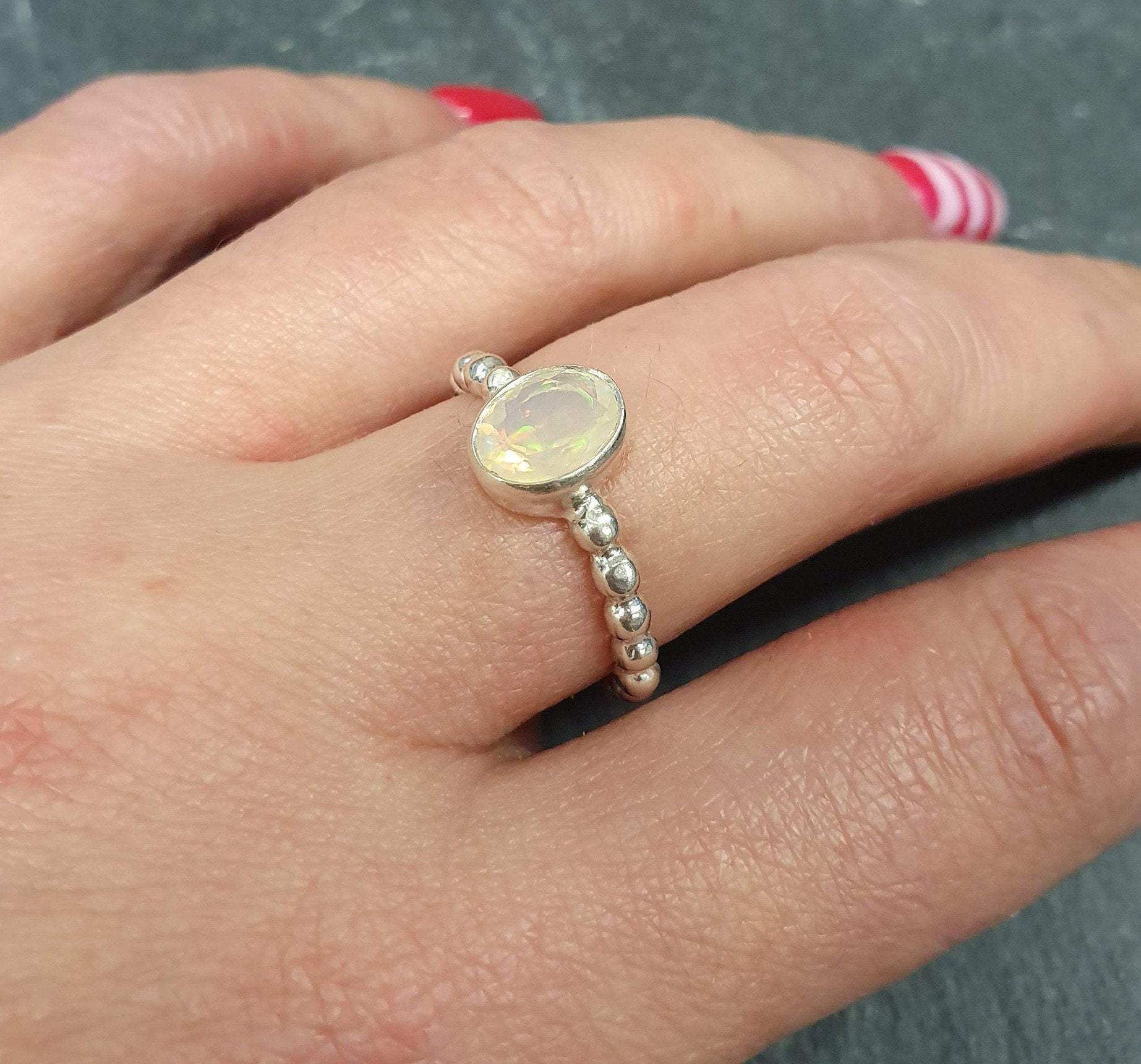 Fire Opal Ring worn on middle finger with bright red nails, styled with striped accent nail art, perfect for expressing individuality and charm, makes a thoughtful October birthstone gift, ideal for casual outings and birthday parties.