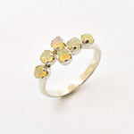 Fire Opal bypass ring in sterling silver with cabochon cut gemstones showcasing flashes of fire colors, crafted in a dainty jewelry style, believed to inspire joy and passion, a meaningful October birthstone gift idea for engagements, birthdays, and cocktail parties.