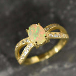 Natural Fire Opal diamond cut in a split gold band with sparkling CZ Diamond accents offering vibrant energy and charm perfect as an October birthstone gift for engagements anniversaries or special celebrations.