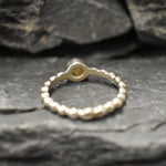 Yellow Fire Opal Bubble Band Ring in sterling silver with bezel set round cut, showcasing flashes of fire colors in a tennis band design for an elegant jewelry style. This durable and timeless piece is a meaningful October birthstone gift idea, symbolizing passion and inspiration. Ideal for birthdays, weddings, anniversaries, and evening occasions where a touch of unique brilliance is desired.