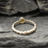 Yellow Fire Opal Bubble Band Ring in sterling silver with bezel set round cut, showcasing flashes of fire colors in a tennis band design for an elegant jewelry style. This durable and timeless piece is a meaningful October birthstone gift idea, symbolizing passion and inspiration. Ideal for birthdays, weddings, anniversaries, and evening occasions where a touch of unique brilliance is desired.