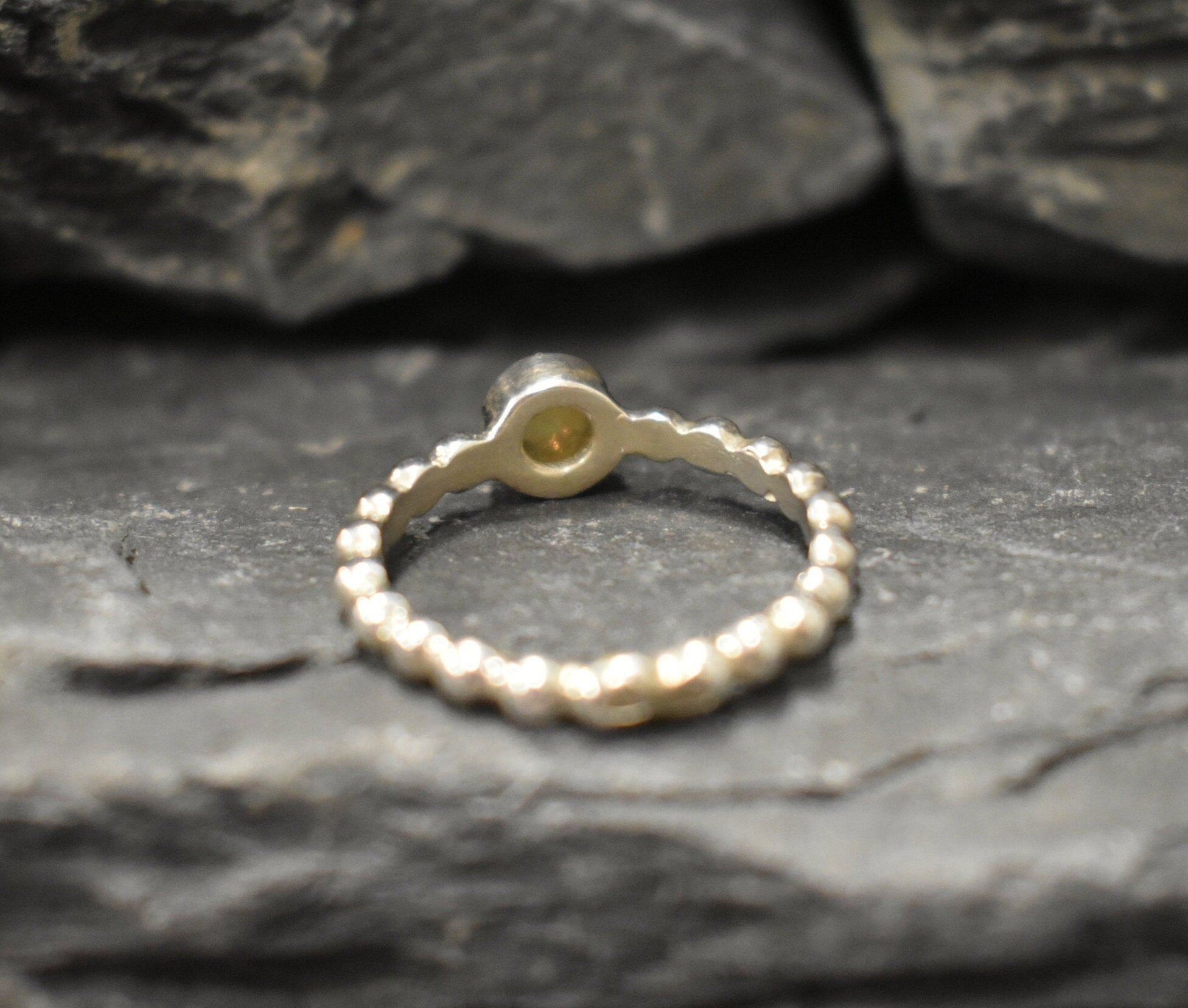 Yellow Fire Opal Bubble Band Ring in sterling silver with bezel set round cut, showcasing flashes of fire colors in a tennis band design for an elegant jewelry style. This durable and timeless piece is a meaningful October birthstone gift idea, symbolizing passion and inspiration. Ideal for birthdays, weddings, anniversaries, and evening occasions where a touch of unique brilliance is desired.