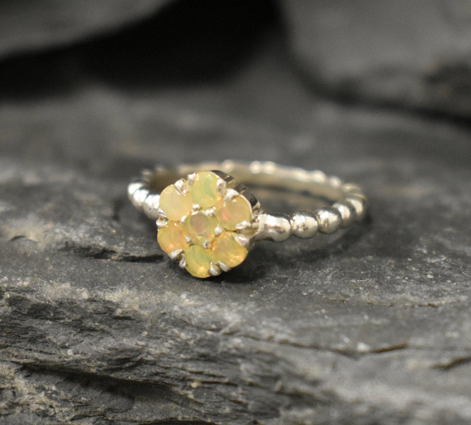 Flower Fire Opal Ring in solid 925 Sterling Silver with dainty bubble band style, designed with flashes of fire colors. Known for its energy of inspiration and positivity, this October birthstone makes a meaningful gift idea for nature lovers and those who adore dainty jewelry styles.
Perfect for anniversaries, birthdays, weddings, and romantic evening events.