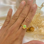 Fire Opal Gold Ring worn on index finger with bare nails styled against a soft neutral background perfect for enhancing elegance and positivity during special events or birthdays.