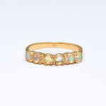 Natural Fire Opal cabochon half eternity ring in gold, designed with dainty cabochon stones for timeless elegance and flashes of fire colors. This ring highlights durability and everyday wear while being lightweight and comfortable. As the October Birthstone, Fire Opal makes a meaningful gift for birthdays, anniversaries, or special occasions. Perfect to wear at weddings, cocktail parties, and festive celebrations.