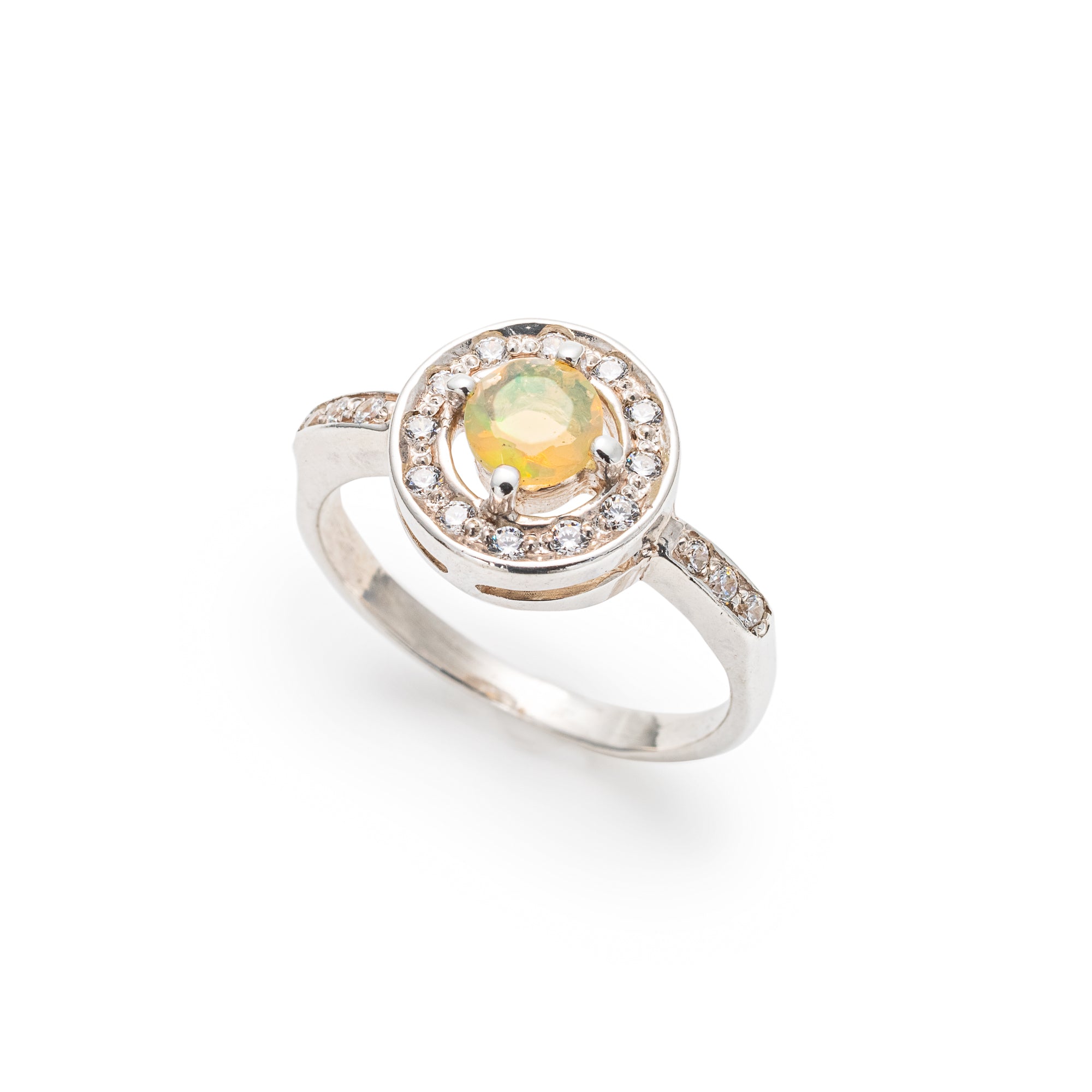 Ethiopian Opal diamond cut halo ring in solid 925 sterling silver, surrounded by sparkling CZ accents for brilliance and elegance. The halo design highlights flashes of fire colors while offering timeless durability. As the October Birthstone, Opal makes a meaningful gift for birthdays, engagements, anniversaries, or personal milestones. Perfect to wear at weddings, cocktail parties, and festive gatherings.