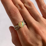 Fire Opal Ring worn on index finger with bare nails perfect for radiating confidence and warmth ideal for romantic evenings or birthday celebrations.