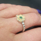 Flower Opal Emerald  Ring worn on middle finger with deep purple nails, the dainty bubble band enhances the floral design. Perfect for balancing emotions and sparking creativity, this October birthstone jewelry makes a thoughtful gift. Ideal for dinner dates, cocktail nights, and artistic gatherings.