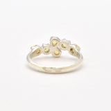 Fire Opal bypass ring in sterling silver with cabochon cut gemstones showcasing flashes of fire colors, crafted in a dainty jewelry style, believed to inspire joy and passion, a meaningful October birthstone gift idea for engagements, birthdays, and cocktail parties.