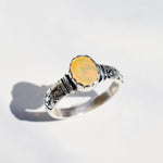 Natural Fire Opal diamond cut tribal engraved ring in solid 925 sterling silver, showcasing flashes of fire colors in a bold boho style. The embossed ornament band ensures durability while offering a unique artistic look. As the October Birthstone, Fire Opal makes a meaningful gift for birthdays, anniversaries, or personal milestones. Perfect to wear at festivals, cultural gatherings, weddings, and evening celebrations.