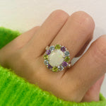 Flower Opal Ring styled for a cocktail look with nude nails and a cozy green sweater. The colorful cluster lifts mood and confidence. Ideal October birthstone gift for evening parties and holiday events.