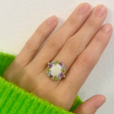 Flower Opal Ring styled for a cocktail look with nude nails and a cozy green sweater. The colorful cluster lifts mood and confidence. Ideal October birthstone gift for evening parties and holiday events.