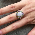 Flower Opal Ring showing a white Opal halo on ring finger with nude nails. Known for hope and calm. A lovely October gift for graduations, anniversaries and dinner dates.