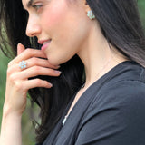 Flower Opal Ring in sterling silver matched with opal earrings and pendant necklace, styled with sleek black blouse, perfect for enhancing personal style and used for anniversaries, holiday parties, and special events.