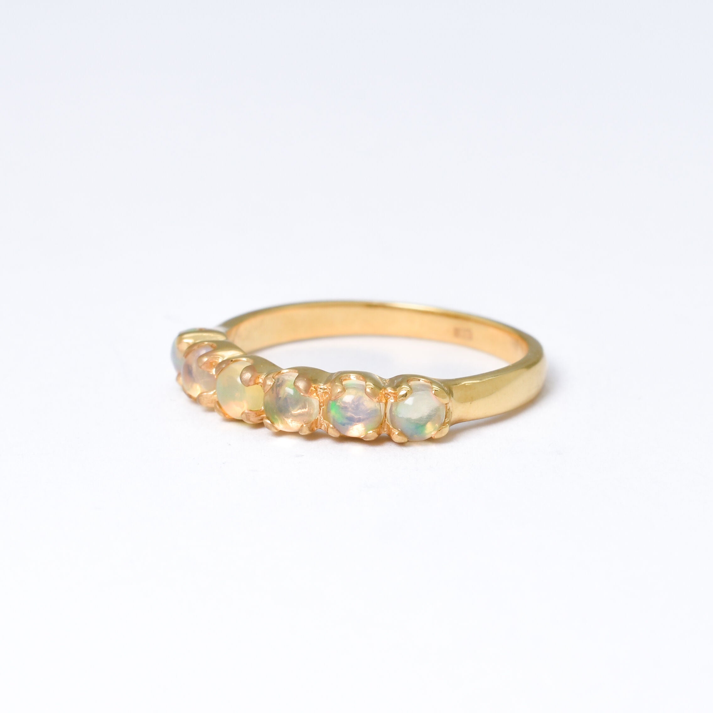 Ethiopian Opal eternity ring in gold with round cabochon gemstones, ideal for stacking or wearing solo, symbolizing everlasting love and inspiration, a meaningful October birthstone gift for weddings, anniversaries, and romantic milestones.
