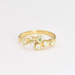 Gold peridot ring featuring natural peridot stones with diamond cut clarity, set in an 18k gold band, perfect for elegant wear and special occasions.