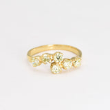 Gold peridot ring featuring natural peridot stones with diamond cut clarity, set in an 18k gold band, perfect for elegant wear and special occasions.
