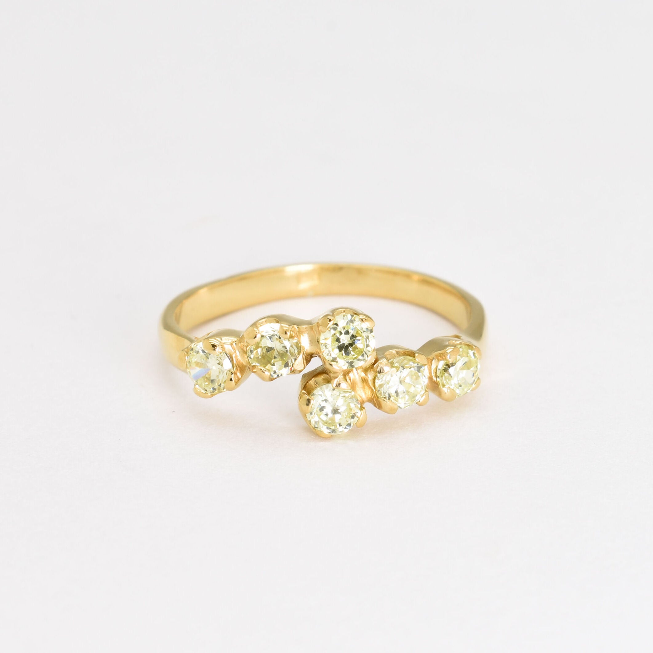 Gold peridot ring featuring natural peridot stones with diamond cut clarity, set in an 18k gold band, perfect for elegant wear and special occasions.