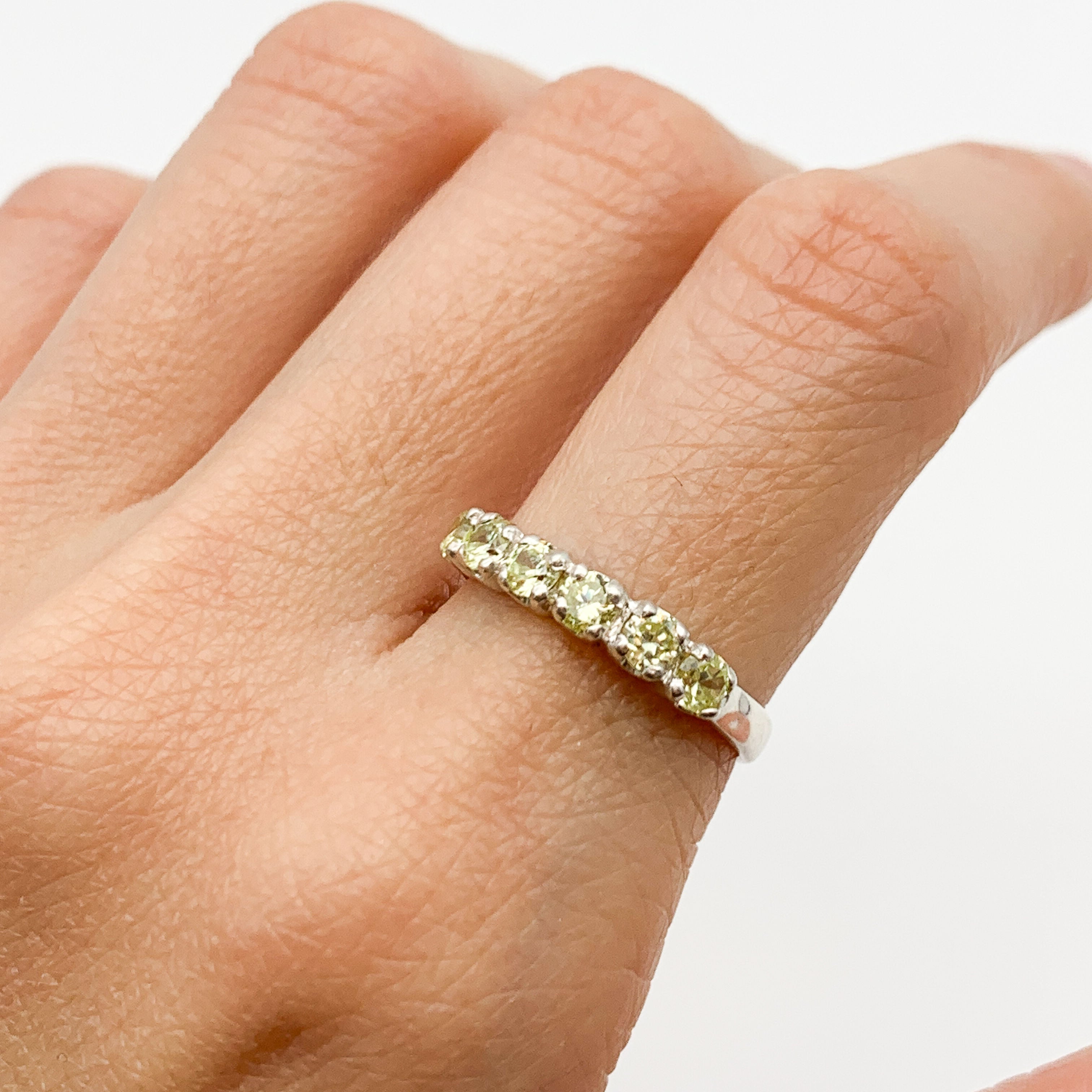 Green Peridot ring styled with natural skin tone and simple nails, perfect for casual or formal occasions, adding subtle elegance to any look.