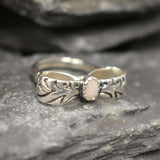 Opal ring in handcrafted solid silver with a ribbon bow style band and white cabochon showing flashes of fire color, a statement design that brightens the hand. Brings creative spark and calm confidence while adding a luminous white accent to any look. A thoughtful October birthstone gift idea for someone special.
Wear to weddings, anniversaries, engagements, date nights, office parties, graduations, and holiday gatherings.