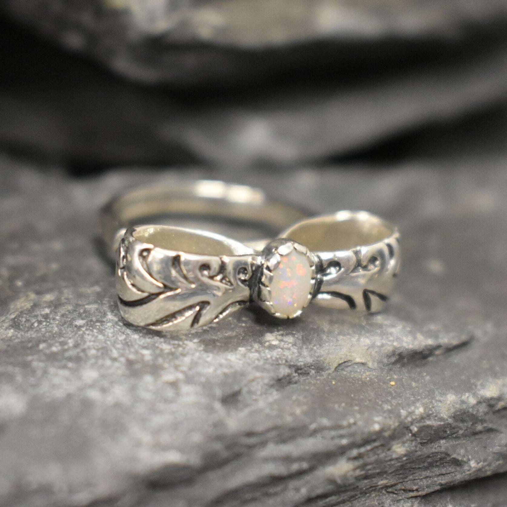 Opal ring in handcrafted solid silver with a ribbon bow style band and white cabochon showing flashes of fire color, a statement design that brightens the hand. Brings creative spark and calm confidence while adding a luminous white accent to any look. A thoughtful October birthstone gift idea for someone special.
Wear to weddings, anniversaries, engagements, date nights, office parties, graduations, and holiday gatherings.