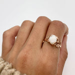 Rose Gold Vine Opal Ring worn on index finger with natural nails, perfect for bringing emotional balance and a touch of nature-inspired elegance, ideal for garden weddings or spring gatherings.