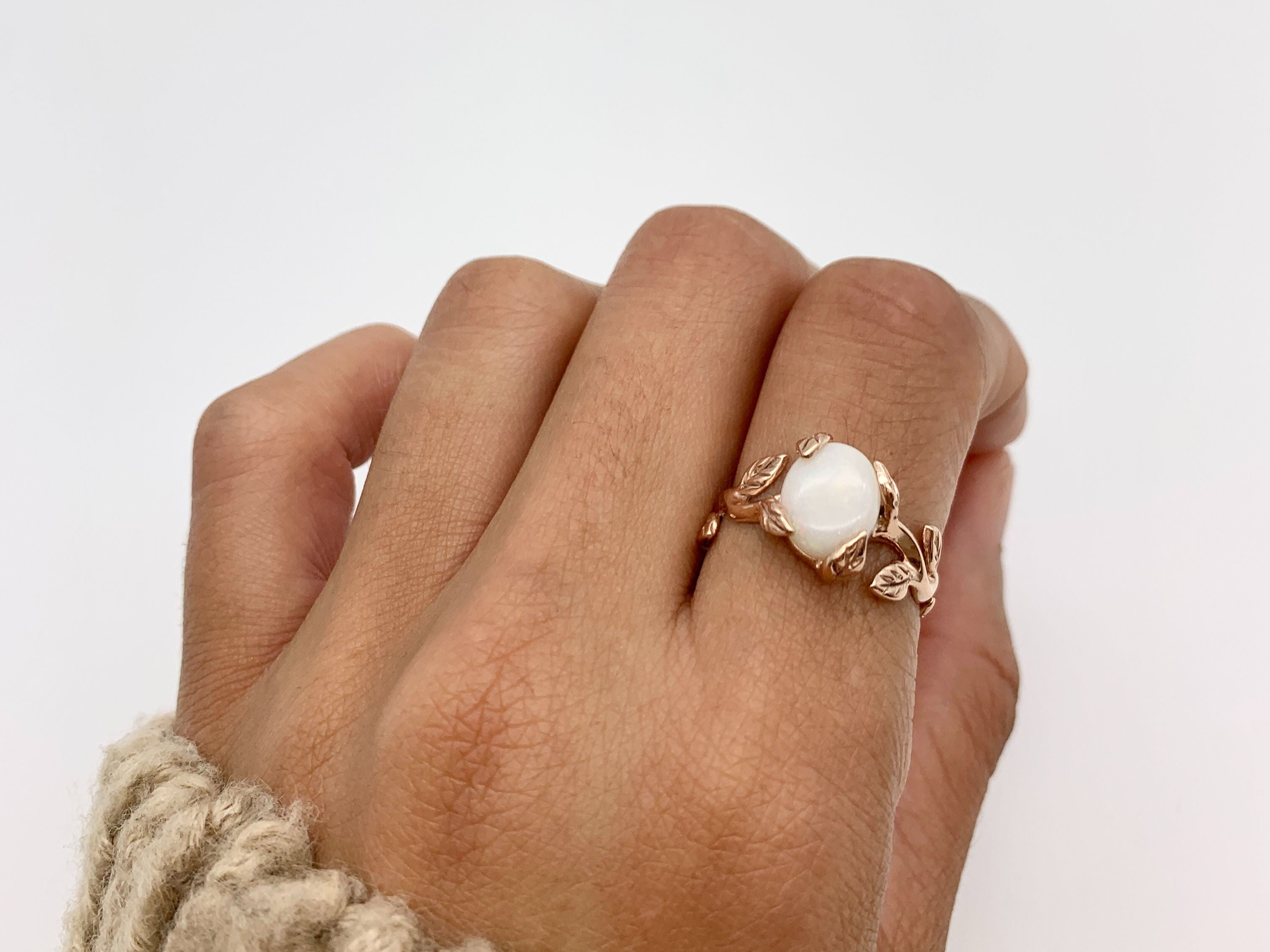 Rose Gold Vine Opal Ring worn on index finger with natural nails, perfect for bringing emotional balance and a touch of nature-inspired elegance, ideal for garden weddings or spring gatherings.