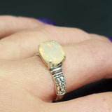 Ethiopian Fire Opal Sterling Silver Ring featuring a horizontal oval cut with a secure 4-prong setting. The engraved ornament band adds vintage charm, while the opal displays brilliant flashes of fire colors. A timeless October birthstone ring, perfect for birthdays, anniversaries, weddings, and milestone celebrations.