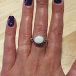 Horizontal Australian Opal Ring worn on middle finger with deep purple nails, white stone showing flashes of fire colors, stylish jewelry design that enhances confidence, symbolic October birthstone gift. Perfect for cocktail parties, evening dinners, and seasonal celebrations.