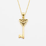 Long Key Pendant set in 18k Yellow Gold Vermeil over Solid 925 Sterling Silver. Gold Key Necklace with Trinity Knot, perfect as a statement necklace, can be styled with maximalist outfit. Trinity knot represents unity, eternal love, and the cycle of existence.