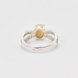 Natural Fire Opal diamond cut in a split sterling silver band with sparkling CZ Diamond accents offering vibrant energy and charm perfect as an October birthstone gift for engagements anniversaries or special celebrations.