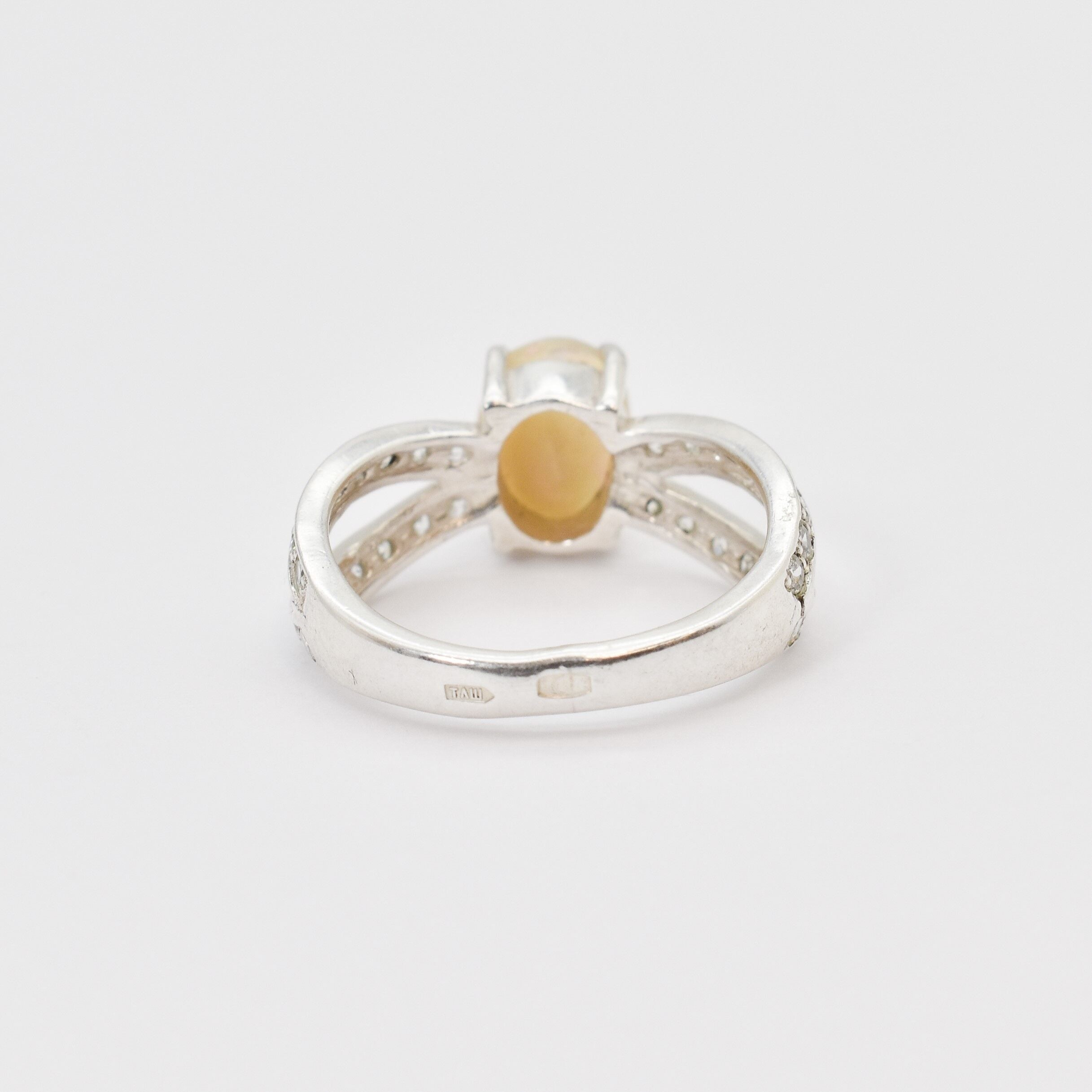 Natural Fire Opal diamond cut in a split sterling silver band with sparkling CZ Diamond accents offering vibrant energy and charm perfect as an October birthstone gift for engagements anniversaries or special celebrations.