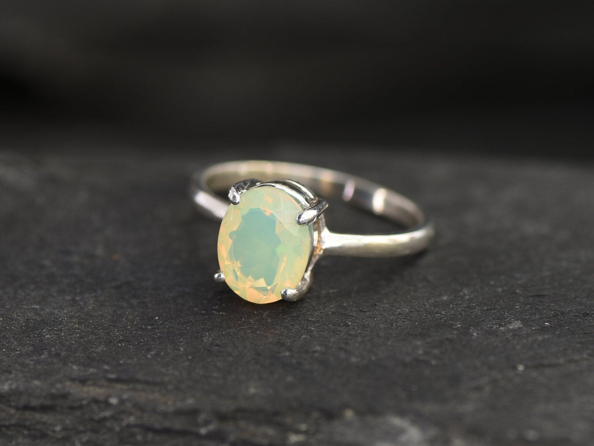 Natural Fire Opal solitaire design in solid silver setting radiating warmth and positivity perfect as an October birthstone gift for engagements anniversaries, promise ring or milestone celebrations.