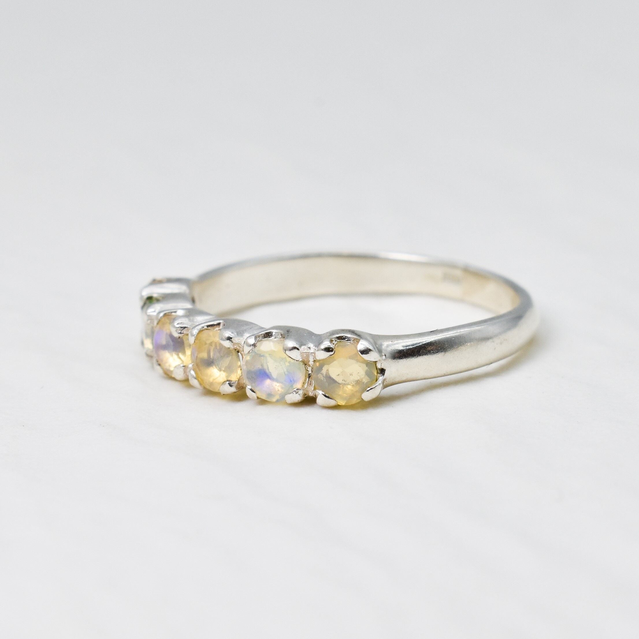 Natural Fire Opal half eternity ring in solid sterling silver, featuring a row of cabochon cut opals, a dainty jewelry piece symbolizing balance and creativity, an ideal October birthstone gift for anniversaries, weddings, or milestone celebrations.