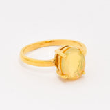 Natural Fire Opal solitaire design in yellow gold setting radiating warmth and positivity perfect as an October birthstone gift for engagements anniversaries, promise ring or milestone celebrations.