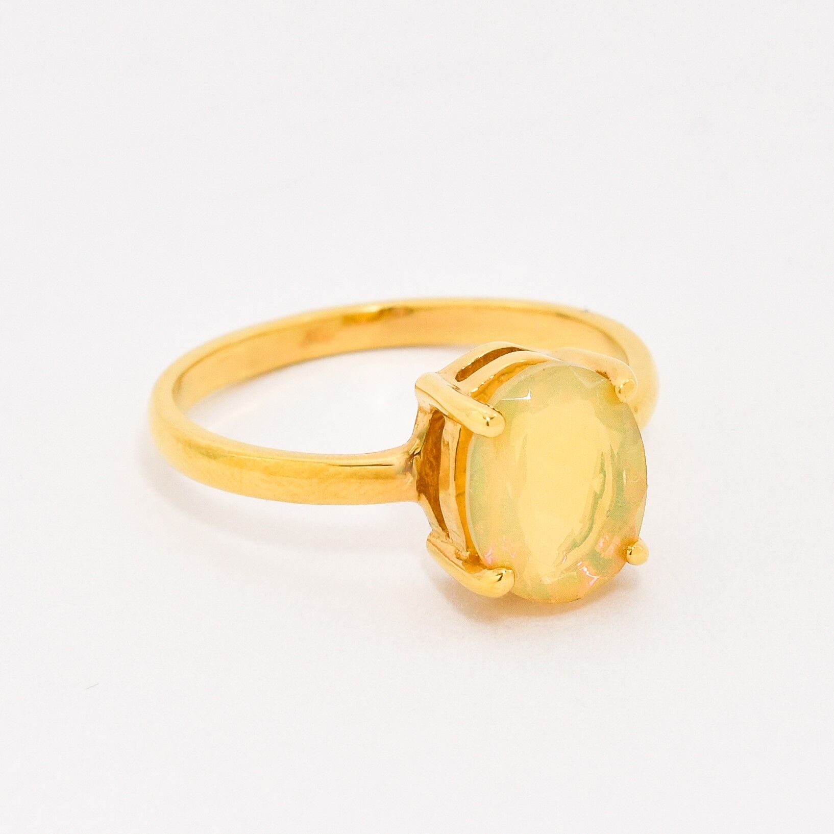 Natural Fire Opal solitaire design in yellow gold setting radiating warmth and positivity perfect as an October birthstone gift for engagements anniversaries, promise ring or milestone celebrations.