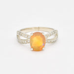 Ethiopian Opal Oval Ring in sterling silver with a 4 prong setting and split shank design. Jewelry style features a CZ pave band that adds brilliance around the opal gemstone, glowing with flashes of fire colors. Opal is known for inspiring creativity, passion, and emotional balance. A meaningful October birthstone gift for birthdays, anniversaries, and special milestones. Perfect to wear at weddings, evening dinners, formal events, and cocktail parties.