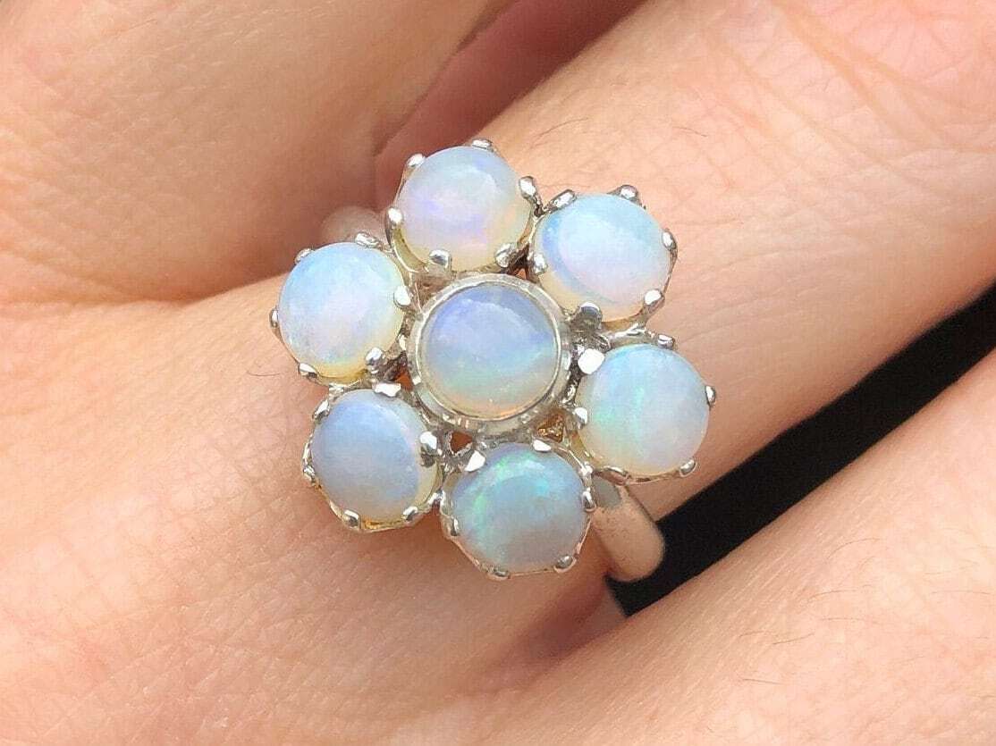 Natural Opal flower ring in sterling silver featuring round cabochon gemstones, ideal for elegant statement style, believed to inspire hope and creativity, perfect as an October birthstone gift for birthdays, anniversaries, and romantic celebrations.