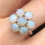 Natural Opal flower ring in sterling silver featuring round cabochon gemstones, ideal for elegant statement style, believed to inspire hope and creativity, perfect as an October birthstone gift for birthdays, anniversaries, and romantic celebrations.