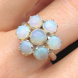 Natural Opal flower ring in sterling silver featuring round cabochon gemstones, ideal for elegant statement style, believed to inspire hope and creativity, perfect as an October birthstone gift for birthdays, anniversaries, and romantic celebrations.