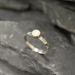 Opal Ring in sterling silver with a hammered textured band and bezel set white opal that shows flashes of fire colors. Opal is linked to creativity, inspiration and emotional balance, making it a meaningful October birthstone gift. A perfect present for birthdays, anniversaries or promise rings. Suitable for daily wear, weddings, parties and special occasions.