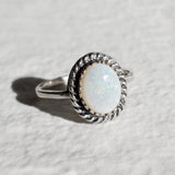 Natural Australian Opal sterling silver ring with an oval cabochon cut gemstone framed by a detailed rope-edge design, offering a timeless and elegant style. Opal, the October birthstone, is valued for enhancing creativity and emotional harmony, making it an ideal gift for birthdays, anniversaries, weddings, and milestone celebrations.