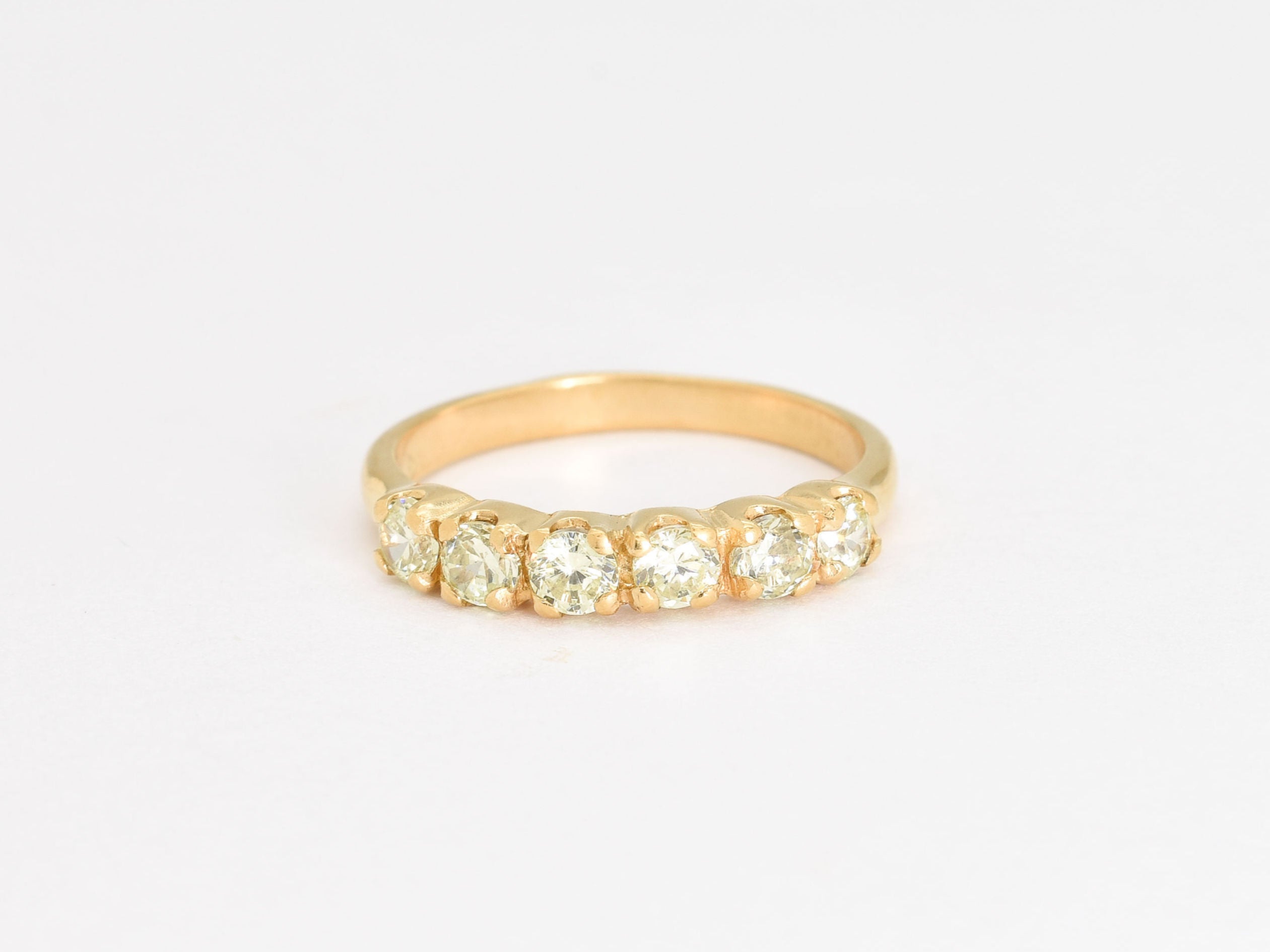 Natural peridot ring set in gold with sparkling diamond cut stones, combining timeless beauty and sophisticated design for everyday or formal use.