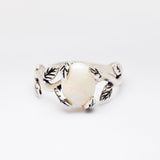 White Opal cabochon vine and leaf ring crafted in solid 925 sterling silver, featuring a nature-inspired design with flashes of fire colors. The durable vine-style band offers elegance and uniqueness while remaining comfortable for daily wear. As the October Birthstone, White Opal makes a thoughtful gift for birthdays, anniversaries, and nature lovers. Perfect to wear at weddings, outdoor celebrations, and festive gatherings.